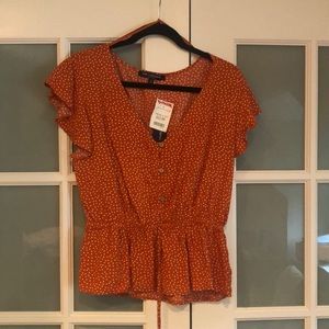 Orange polka dot peplum top